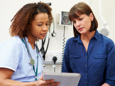 A primary care clinician reviews information with a patient