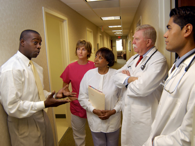 A practice facilitator talks to a group of primary care clinicians.