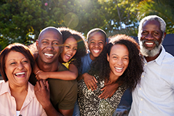 Six people in a multigenerational Black family, outside and smiling