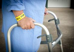 Photograph of elderly person with a walker.