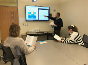 Bob Armstrong, executive director of the simulation center at Eastern Virginia Medical School, reviews the AHRQ Healthcare Simulation Dictionary with members of his team.