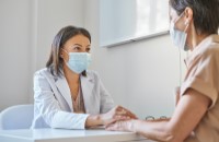 Supportive Female Doctor speaks with patient